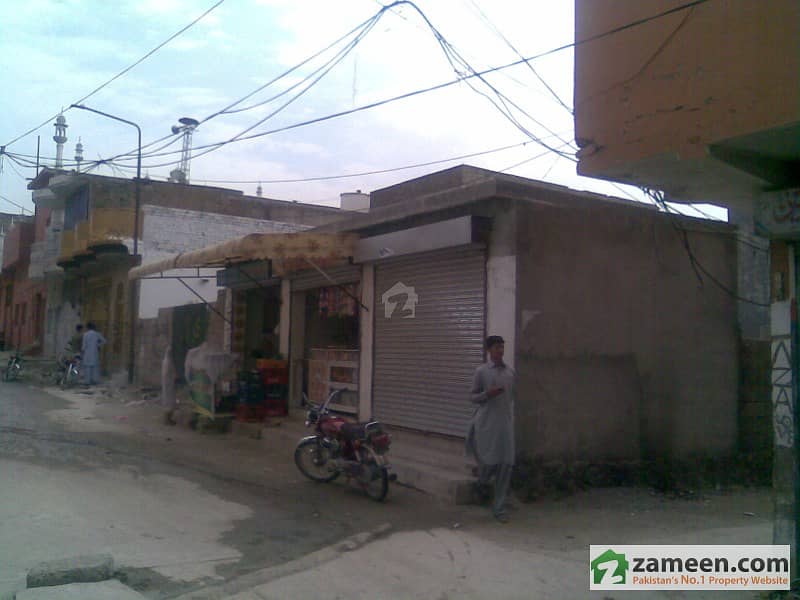 10 Marla Plot Having Boundary Wall Around It And 3 Shops Are Also Constructed. 