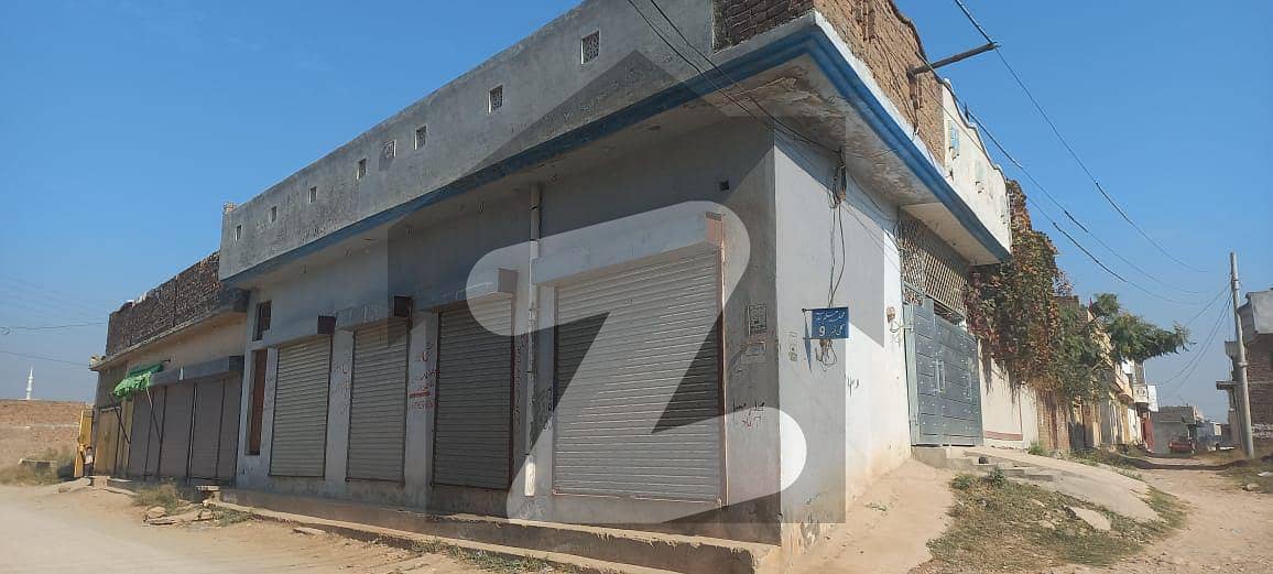 10 Marla Corner House with 4 Shops for Sale
