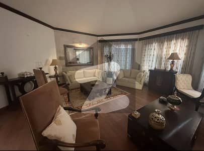 Luxury 1000-Yard House for Rent in DHA Phase 5 - Prime Location, Spacious 5 Bedrooms, Massive Lawn, 7-8 Car Parking, and Solar System for Reduced Electricity Costs