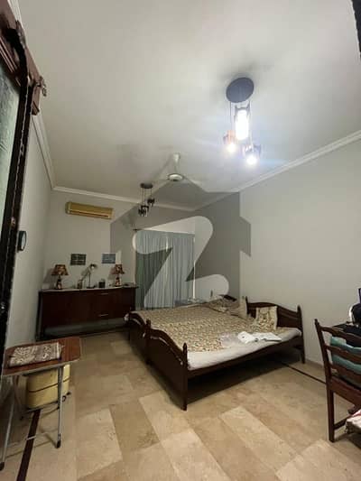Perfect Blend of Style & Durability 1-Kanal Double Unit Slightly Used Bungalow for Sale with Lush Lawn, Sunlit Interiors, Exceptional Craftsmanship, and Premium Building Materials Ensuring Long-Term Value