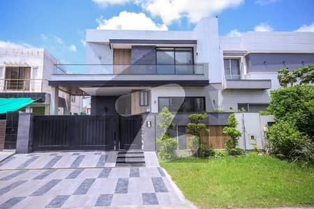 Prestigious 10-Marla DHA Phase 5 Mansion Brand New Independent Bungalow Featuring 5 Master Bedrooms with Baths, Elegant Woodwork, 2 Kitchens, TV Lounge, Drawing & Dining, Store & Servant Quarter Modern Design, Serene Location, Fast Deal!