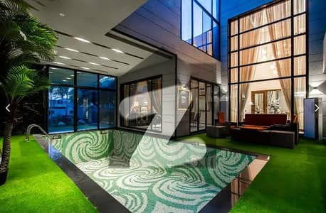 OUTDOOR SWIMMING POOL 1 KANAL ULTRA MODERN FULLY FURNISHED BUNGALOW WITH DOUBLE HEIGHTED TV LOUNGE FOR SALE IN DHA PHASE 6 NEAR TO RAYA.