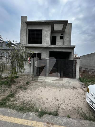 On 40-foot wide road 5.5 Marla Grey Structure House for Sale In Crystal Block Park View City Lahore