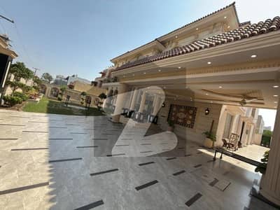 The Epitome of Luxury in Valencia Town! Magnificent 2 Kanal Mansion for Sale on a wide 80ft Road.  Featuring 7 Grand Bedrooms and 9 Modern Bathrooms.