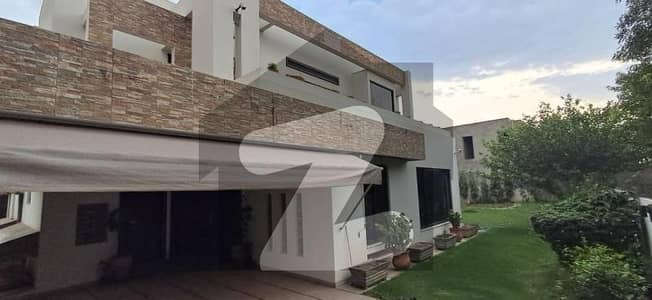 2 Kanal Top Location Bungalow (1 Kanal Lawn) With 2 Servant Quarter And Basement Is Available In The Best Block Of DHA Lahore Near Dolmen Mall.