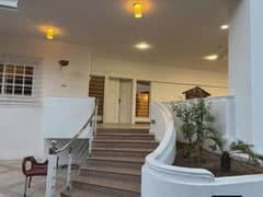 MAGNIFICENT 1200 SQ YD 7-BEDROOM CORNER BUNGALOW FOR RENT ON KHAYABAN-E-MUJAHID DHA PHASE 5