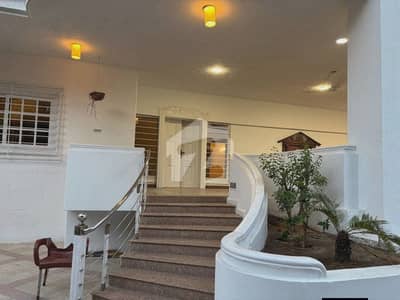 MAGNIFICENT 1200 SQ YD 7-BEDROOM CORNER BUNGALOW FOR RENT ON KHAYABAN-E-MUJAHID DHA PHASE 5