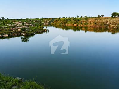 Area of 1350 Kanal in Mouza Khesa. 9 kilometers from Doltala, near Ahdi Gas Field. Clean, possessed, resale and populated area. Computerized individual owner. Private large water storage dam for the area. Approximately 800 meters, 2400 feet frontage on the link road. Excellent area for agro farming, and also excellent for fish farming due to the presence of a private dam. Demand is 400,000 per Kanal.