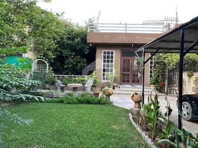 Beautiful 17 Marla Family House with Lush Garden & Covered Car Parking